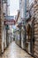 Narrow street of the old city. Ancient houses made of stone. Old Town of Budva.