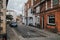Narrow street with parked cars and traditional architecture in the village of Canterbury, Kent, England
