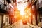 Narrow Street perspective view with colorful traditional houses, in the sunlight. cobblestone pavement in the historical centre of