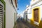 Narrow street of Salema village. Ocean view and whitewashed houses of the small fishing village. Faro, Algarve, Southern Portugal.