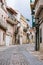 Narrow street in small european town. Mediavel buildings in Italy. ravel and summer tourism concept. Ancient architecture.