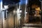 A narrow street with stairs and lanterns on the wall at night in Pylos, Greece