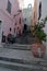 Narrow street with steep stairs leading up the hill towards Doria castle