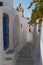 Narrow street in traditional Cyclades style Emporio village