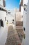 Narrow street in the traditional fishing village of Binibeca on the coast of Menorca, Spain.