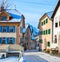Narrow street with typical houses in the older part of Guarda at sunny winter morning, Inn District, Swiss canton of Graubunde