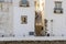 Narrow street uphill between two white houses in Tavira, Portugal