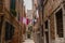 Narrow street in Venice. Above the street on the clothesline hung hung clothes washed.