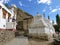 Narrow street with white lined up stupas to Leh in the  Ladakh in India.