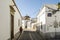 Narrow street with whitewashed buildings in Faro, Algarve, Portugal