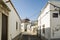 Narrow street with whitewashed buildings in Faro, Algarve, Portugal