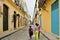 On the narrow streets of the historical center of Havana, old houses, pavement made of stone, old street lamps on the walls of hou