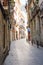 Narrow streets with medeival architecture in Alicante old town historic district Santa Cruz on the way to Santa Barbara mountain