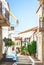 Narrow streets of Neorio town in Poros island, Greece; Old whit