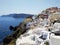 Narrow streets in Oia, Santorini island, Greece. White houses, blue sea.