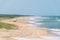 Narrow stretch of sand between the brazilian atlantic ocean and the vegetation that grows on it, tire trails and