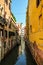 Narrow venetian canal on a sunny day