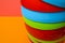 Narrow view of a colorful stack of plastic bowls - abstract colorful background