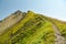 Narrow walking trail on ridge leading to Brisen peak in Swiss Alps