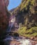 The narrow waterfall, Spanish: Cascada del estrecho. Wild landscape with the mists and sunbeams mixed with the vegetation of the