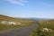 Narrow winding country road over moorland, Cumbria