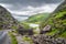 Narrow winding road and stone bridge with a view on Gap of Dunloe valley