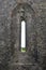 Narrow window in medieval stone wall