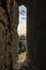 Narrow window in stone wall with view of beautiful Paris cityscape