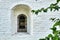 Narrow window in the wall of an ancient building in the Joseph-Volotsky russian monastery