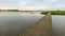 Narrow wooden footbridge over the water of a nature reserve