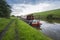 Narrowboat on a British canal in rural setting