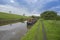 Narrowboat on a British canal in rural setting