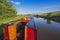 Narrowboat on a British canal in rural setting