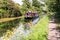 A narrowboat makes its way along the Grand Union canal