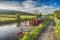 Narrowboat moored on a British canal in rural setting