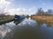 Narrowboat moored on a British canal in rural setting