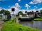 A narrowboat owner opens the electric swing bridge at New Lane on the Leeds to Liverpool Canal near Burscough in Lancashire, UK.