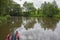 Narrowboat traveling on a British canal in rural setting