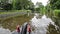 Narrowboat traveling on a British canal in rural setting