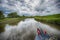 Narrowboat traveling on a British canal in rural setting