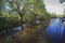 Narrowboat traveling on a British canal in rural setting