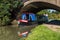 Narrowboat under Candle Bridge on a bright day