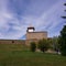 Narva Castle against the backdrop of green lawn and blue summer sky.