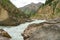 The Naryn River flows between huge boulders