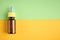 Nasal drops bottle composition, glass bottle on yellow and green background