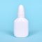 Nasal spray, drops in white bottle. Isolated on blue background