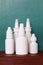 Nasal spray nose drops white vials on a green background