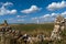 The Nash Point Lighthouse framed by an old stoen wall and farm fields