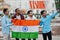 Nashik city inscription. Group of four indian male friends with India flag making selfie on mobile phone. Largest India cities