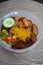 Nasi Ambeng or Nasi Ambang. It is a fragrant rice dish that consists of steamed white rice, chicken curry or chicken stewed in soy